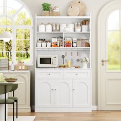 a kitchen with white cabinets and open doors