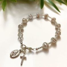 Bead: Freshwater Pearl & Clear Swarovski Crystal Size: CustomCharms: Cz Cross, Mother Mary If you have any other questions, please feel free to send me a message! Elegant Pearl Jewelry For Confirmation, Adjustable Beaded Rosary Bracelet For Wedding, Elegant Silver Rosary For First Communion, Silver Baptism Jewelry With 8mm Beads, Elegant Rosary Bracelet With Round Beads For Baptism, Silver Beaded Rosary For First Communion, Elegant Rosary Bracelet With Round Beads For First Communion, Elegant Rosary Bracelet For First Communion With Round Beads, Adjustable Rosary Bracelet With 8mm Beads For Wedding