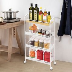 a rack with bottles and containers on it next to a table