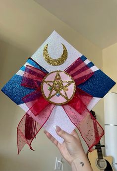 someone is holding up a star and crescent decoration