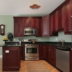 a kitchen with wooden cabinets and stainless steel appliances