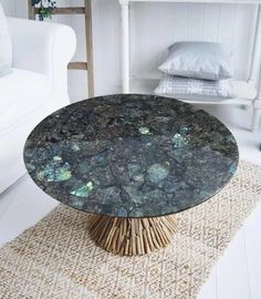 a table that is sitting in the middle of a room with a rug on the floor