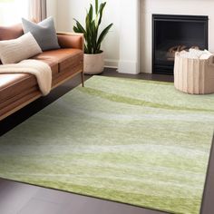 a living room with a couch, chair and rug in front of a fire place