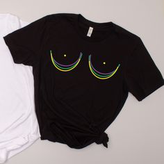 two t - shirts with eyes drawn on them are laying next to each other,