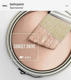 a pink paint can with a brush in it and the words sunset drive painted on it