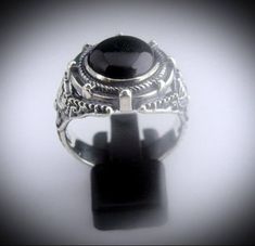 Our Version of the ring Johnny Depp wore in the movie Dark Shadows but we have made it in all sterling silver with a Black Onyx Stone set into the ring. Face of Ring is 20 mm wide by 18 mm high Set with a genuine Black Onyx Stone. Made in our studio by our own skilled silversmith artisans it has been oxidized to give it an antique look. We make to size so you need to provide us with your ring size in US or UK. Delivery is by DHL Express included in price. It takes around 10 to 14 days to make th Unique Black Sterling Silver Engraved Ring, Black Gothic Collectible Rings, Victorian Style Black Sterling Silver Rings, Victorian Black Sterling Silver Rings, Silver Gothic Rings For Formal Occasions, Gothic Style Silver Ring With Gemstone, Gothic Silver Ring With Gemstone, Gothic Oval Rings For Formal Occasions, Gothic Hallmarked Rings For Collectors