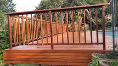 a wooden deck next to a swimming pool