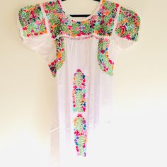 Mexican Dress Fine Handmade San Antonino Intricate Colorful Cotton Thread Hand Stitched Cotton Embroidery Work. Mexican Medium Weight Cotton Fabric. Length: Stylish Up To Maxi Dress 54" /56" Scoop Neck With Crochet Details. Cap Style Sleeve With Hand Embroidered And Crochet Details. Bust Up To 24" Embroidered Front And Back. Contemporary Fit Pieces Are Handmade Garment, Color, Design And Embroidering Variations Are Inherent In The Hand Process, Which Adds To The Unique Beauty Of Garment. (Please Fitted Multicolor Embroidered Dress For Fiesta, Fiesta Floral Embroidered Dress, White Dresses For Cinco De Mayo Fiesta, Embroidered Multicolor Dress For Cinco De Mayo, Multicolor Embroidered Fiesta Dress, Multicolor Spring Dresses With Embroidered Border, Multicolor Embroidered Dress For Fiesta, Fitted White Embroidered Dress With Embroidered Border, Fitted White Embroidered Dress With Border