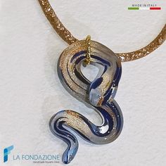 Necklace made of crystalline mesh with snake-shaped pendant made of Murano glass, gold and brown aventurine. The snake is about 6.5 cm long and can be made in different colors. An original necklace that stands out with all types of clothes. Each glass jewel is shipped in a rigid gift box, with the possibility of attaching your own greeting card. Choose unique gifts with style from Venice! If this is not the necklace for you, we have many more in our Etsy shop https://www.etsy.com/it/shop/LaFonda Unique Murano Glass Necklaces As Gifts, Unique Murano Glass Necklace For Gift, Handmade Snake-shaped Necklace For Gift, Handmade Snake Shape Necklace Gift, Gold Murano Glass Jewelry For Gifts, Handmade Snake Necklace For Gifts, Gold Murano Glass Jewelry As Gift, Handmade Snake Shape Necklace For Gift, Gold Murano Glass Jewelry Gift