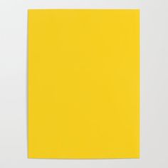 a yellow piece of paper on a white surface