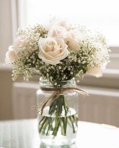 a vase filled with white flowers on top of a table