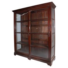 an old wooden bookcase with glass doors