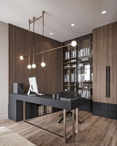 an office with a desk, bookshelf and cabinets