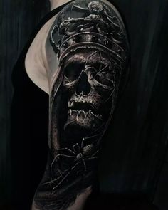 a man with a skull and cross tattoo on his arm