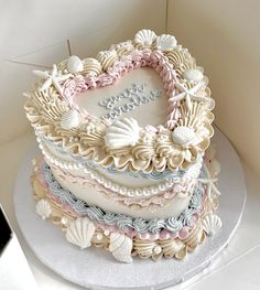 a heart shaped cake with seashells on it