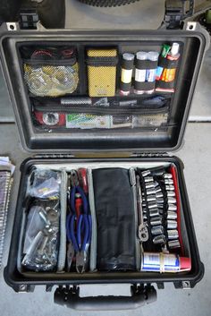 an open suitcase filled with tools and other items