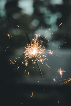 a sparkler that is lit up in the dark with lots of light coming from it