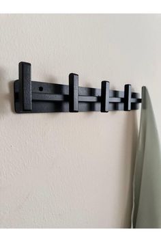 a wall mounted coat rack with hooks on it