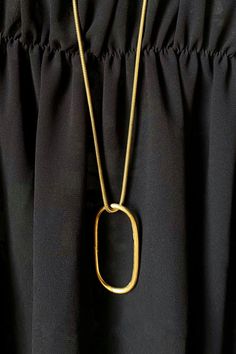 The pendant’s oblong silhouette earns it the name 'Adas' or ‘lentil' in Arabic. Because of Adas' long 29.5" chain, she offers a relaxed touch to any look. A simplistic design with a wide range of wearability. Sister style in the Adas Collection. Metal Chain Necklace With Oval Pendant, Modern Necklaces With Rectangular Pendant And Cable Chain, Minimalist Rectangular Pendant Chain Necklace, Oval Brass Necklace With Adjustable Chain, Minimalist Brass Necklace With Oval Pendant, Elegant Brass Necklace With Rectangular Pendant, Gold Oblong Necklace With Cable Chain, Elegant Oblong Necklace With Adjustable Chain, Modern Metal Necklace With Oval Pendant