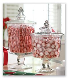 candy canes in glass containers on a table