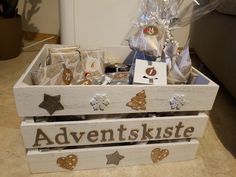 a wooden box filled with lots of different types of items and decorations on top of a table