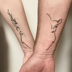 two people holding hands with tattoos on their arms and one has a deer's head