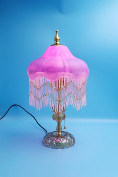 a pink table lamp on a blue background