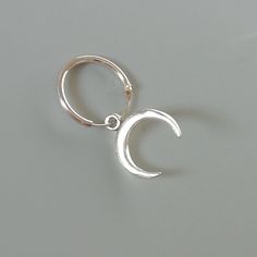 A PAIR of sterling silver hoops. Comes with a detachable crescent moon charm. The charm is multipurpose and can be used with a neck or bracelet chain too. Dimension: Hoop- 12x1 mm Charm- 10 x 12 mm Drop length- 22mm Weight: 1 gm This piece is made of 925 hypoallergenic sterling silver. Please note this price is for ONE Pair only. Sent in a gift box. I can include a personal message from you if needed You are welcome to contact me at... bhavnakwintra1956@gmail.com For more beautiful pieces from m Minimalist Bohemian, Hoops Silver, Evil Eye Earrings, Thread Earrings, Bracelet Chain, Earrings Minimalist, Moon Charm, Bohemian Earrings, Sterling Silver Hoops