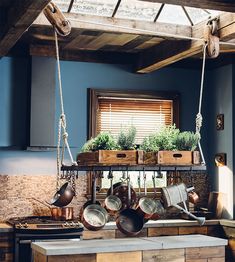 pots and pans hanging from the ceiling in a kitchen