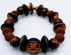 Complemented by a combination of carefully selected beads, and earthy wood these beads symbolize strength, serenity, and the interconnectedness of all things. Note: The bracelet runs small. 5.5-6.5 inches Spiritual Wooden Beaded Bracelets, Adjustable Wood Bracelets For Meditation, Brown Wooden Bracelet With 8mm Beads, Earthy Brown Beaded Bracelets With Round Beads, Artisan Wooden Beads Bracelets For Meditation, Earthy Wooden Beaded Bracelets As Gift, Earthy Wooden Beaded Bracelets For Gift, Adjustable Wooden Beaded Bracelets For Meditation, Brown Wooden Bracelets With Round Beads