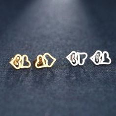 PRODUCT DESCRIPTION: Nine designs! Silver or Gold! Your favorite has to be here! Choose the stainless steel stud earring that fits YOU! Heart, feather, flower, snowflake, musical note, double heart, cross, star, or butterfly. These designs fit the minimalist, suit simplicity, and are appropriate for any age, gender or occasion. If you have multiple piercings, wouldn't these be cute as the second pair? Or picture these in the ears of a young one - they would surely be a hit! Packaged in a blue or Cute Nickel-free Stainless Steel Jewelry, White Metal Heart Earrings For Gift, White Metal Heart Earrings Gift, Silver Stainless Steel Earrings For Valentine's Day, Silver Stainless Steel Heart Earrings For Valentine's Day, Valentine's Day Silver Heart Earrings In Stainless Steel, Valentine's Day Stainless Steel Heart Earrings, Nickel-free Double Heart Stainless Steel Jewelry, Trendy Earrings For Anniversary And Mother's Day