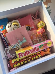 a box filled with assorted candy and other items