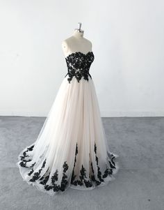 a black and white wedding dress on a mannequin headdress in front of a white wall