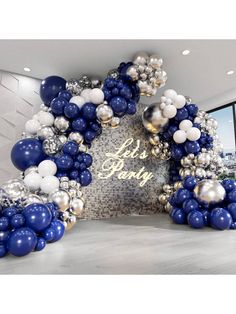 an arch made out of balloons with the words let's party written on it