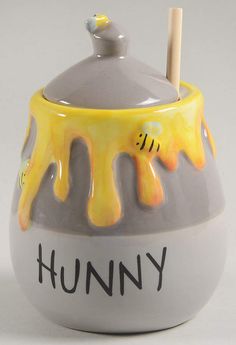 a yellow and gray ceramic cup with the word funny painted on it