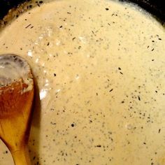 a wooden spoon in a pot filled with soup