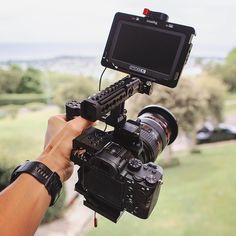 a person holding a camera up to take a picture