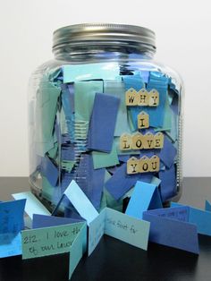 a jar filled with lots of blue paper and some words on the inside of it