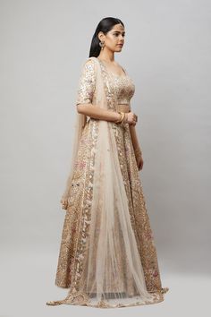 Entirely handcrafted with zardosi and crystal embroidery, this blush pink lehenga is a stunner! Fabric: Pure silk All preorders will be handled by a Nazranaa Bridal Consultant who will virtually discuss measurements and minor changes according to the client's specifications Occasion: Wedding Ceremony or Wedding Reception WASH CARE INSTRUCTIONS - Please Dry clean only when it is applicable. Slight color variation is possible due to digital photography. Jewelry not included Peach Lehenga With Traditional Drape For Reception, Traditional Embellished Beige Lehenga, Traditional Drape Peach Lehenga For Reception, Bollywood Style Embellished Beige Lehenga, Floor-length Peach Lehenga For Reception, Peach Floor-length Lehenga For Reception, Floor-length Peach Choli For Reception, Peach Anarkali Set With Resham Embroidery For Reception, Festive Beige Lehenga With Zari Work