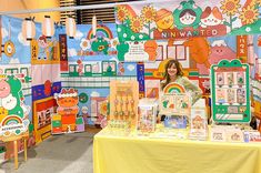 a woman standing in front of a display of children's toys