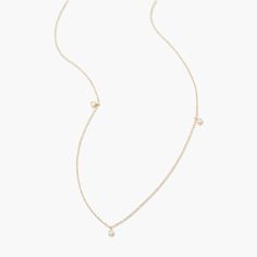 This Juliet 14K Gold Floating Diamond Necklace is a sparkly sensation. With three floating diamonds encased in luxurious 14K gold, this necklace adds a touch of sophistication and glamour to your look - you deserve it! Available in 14k yellow gold Pendant size: 1/8" Lab Grown Diamonds Diamond size: 1.7mm round diamond 16" cable chain with 2" extender Spring ring closure SKU: BYND0008 Gold 14k Diamond Necklace With Single Diamond, Classic Gold Diamond Drop Necklace, Minimalist Gold Diamond Drop Necklace, Fine Jewelry Yellow Gold Drop Necklace With Diamond Accents, Gold Diamond Drop Necklace Fine Jewelry, Everyday Luxury Yellow Gold Diamond Necklace With Delicate Chain, Yellow Gold Drop Necklace With Diamond Accents, Dainty Gold Diamond Station Necklace, Yellow Gold Drop Necklace For Anniversary