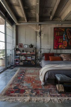 a bed sitting in a bedroom next to a painting on the wall and a rug