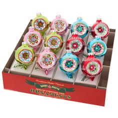 twelve christmas ornaments in a display box