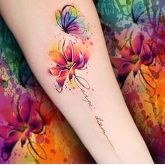 a woman's arm with flowers painted on it and the word love written in cursive writing