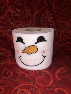 a roll of toilet paper with a snowman face on it