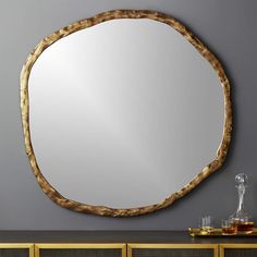 a round mirror sitting on top of a table