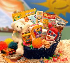 a teddy bear is sitting in a basket filled with toys and books, along with other items