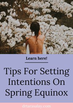 a woman standing in front of white flowers with the words tips for setting intentions on spring equinox