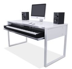 a computer desk with a keyboard, monitor and speakers sitting on it's sides