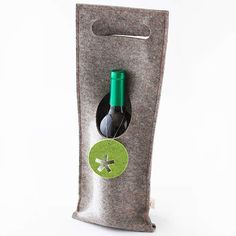 a wine bottle in a bag with a green button on the side and a white background